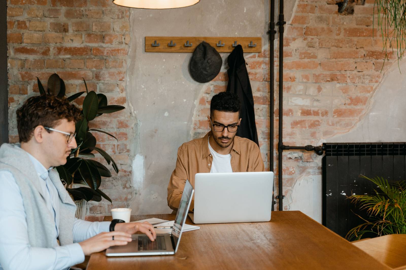 Two candidates working at laptops